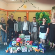 Synectic staff delivering Christmas gifts to Migrant Resource Centre MRC North, photo with MRC staff and clients
